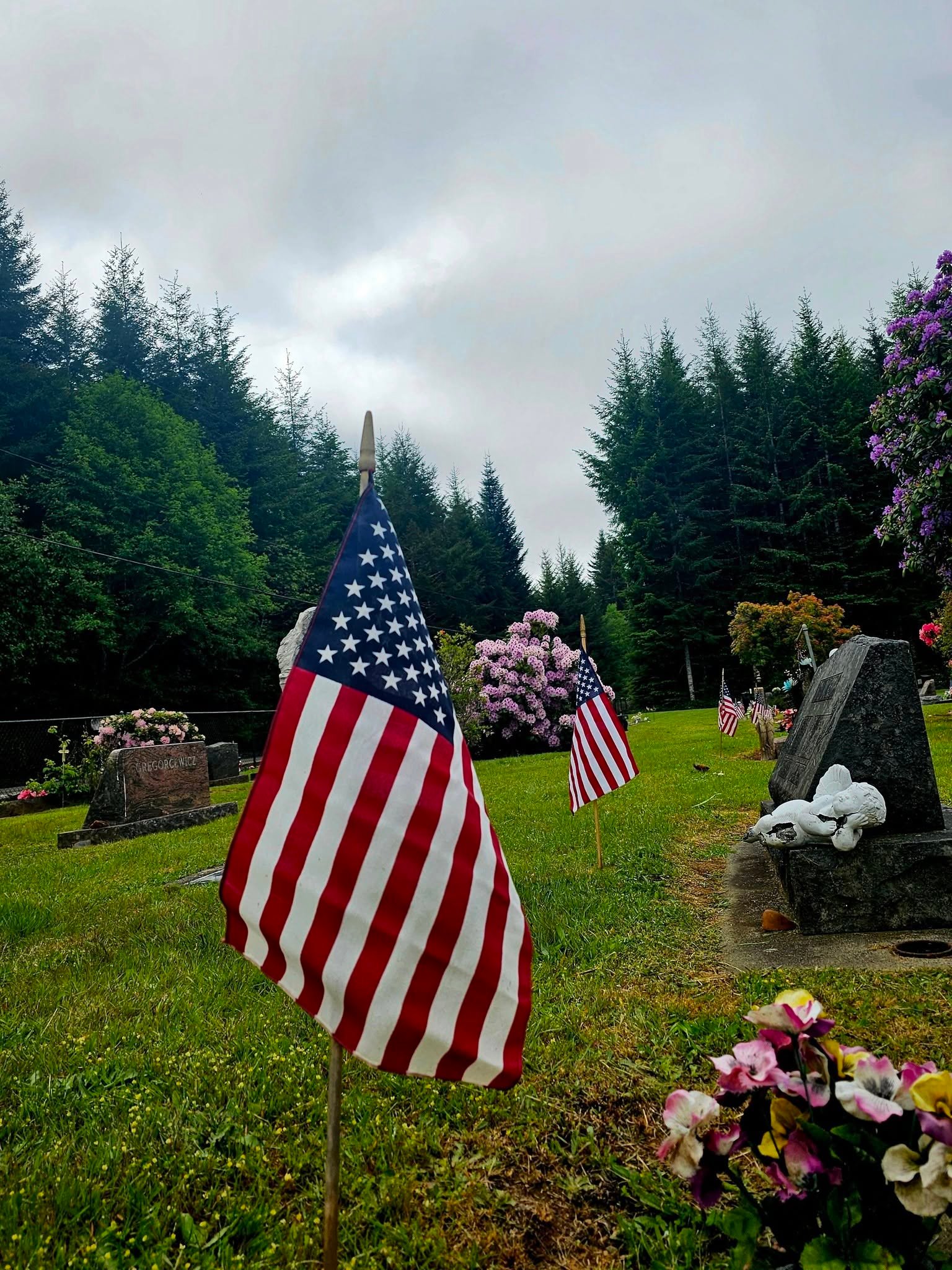 American flags placed among memorials at St. John’s Cemetery on Memorial Day